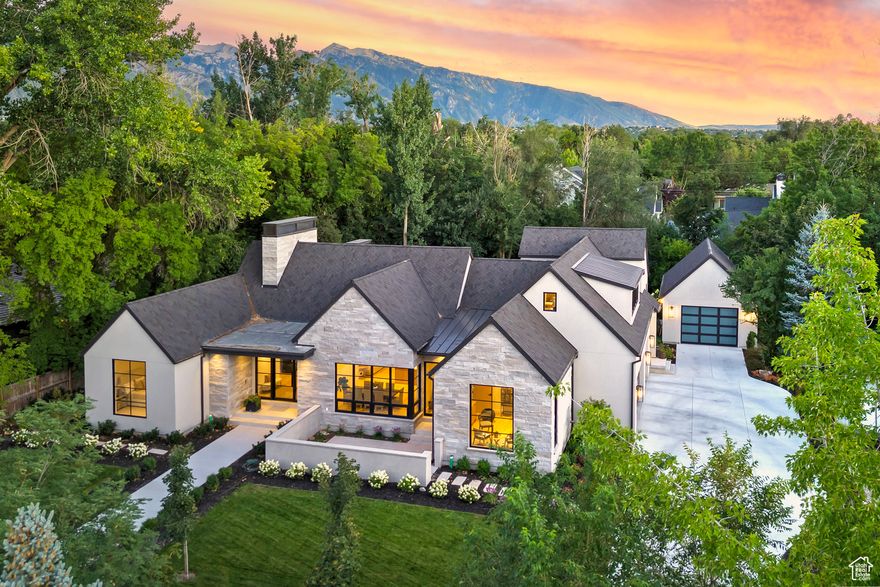 Stunning New Home in Holladay - Exceptional Living on 1/2 Acre Lot Welcome to this extraordinary new residence nestled in the heart of Holladay, set on a beautifully landscaped 1/2-acre lot adorned with mature trees and a soothing stream. This remarkable home showcases elegant craftsmanship and high-end finishes throughout. Step inside to discover rich White Oak floors leading you to breathtaking cabinetry complemented by top-tier luxury appliances. The gourmet kitchen is a chef's dream, featuring a Wolf induction cooktop, double ovens, dual refrigerator drawers, an ice maker, and an expansive walk-in pantry. The spacious 15-foot center island creates a perfect gathering space while offering stunning views through abundant, light-filled windows. The upper level boasts a versatile suite that can serve as an extra bedroom or an opulent playroom, providing flexibility for your lifestyle needs. The beautifully designed lower level is adorned with plush wool carpet and features a cozy fireplace, as well as a golf simulator and a wet bar equipped with Subzero appliances for your entertainment. Thoughtfully designed, this home is wired for electric blinds in key areas, including the office, main guest room, family room, entryway, and master bedroom for added convenience and elegance. Additional amenities include a Lutron lighting system, two EV chargers, a tankless water heater for efficient living, and a detached garage featuring built-ins with potential workshop space. Don't miss the opportunity to own this rare new find in Holladay, where luxury meets tranquility. Schedule your private showing today! *Square footage provided as a courtesy. Buyer is advised to obtain independent measurements and verify all information.*