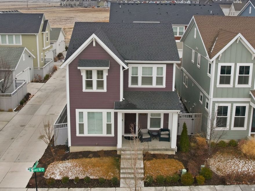 NEW PRICE! Located in the highly sought-after Daybreak community, this upgraded corner-lot two-story home offers 9-foot ceilings and an open main level featuring the kitchen, family room, dining area, and half bath. The kitchen showcases upgraded soft-close cabinetry, granite countertops, and upgraded fixtures. The primary suite includes double sinks and tile flooring, and the newly finished basement adds a studio, bedroom, and full bath with a jetted soaker tub. The garage stands out with an extra-tall door for oversized vehicles, added width for a workshop, and overhead storage racks. Residents enjoy access to a watercourse for paddleboarding and kayaking, Oquirrh Lake, extensive trails, sports courts, pools, splash pads, and community events.