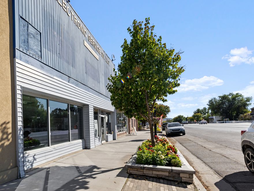 Prime mixed-use building in the heart of downtown Nephi with exceptional income potential. This versatile property offers a rare opportunity for both commercial and residential use, making it ideal for investors or those seeking a live/work environment. The main-floor commercial storefront features large, street-facing windows along Main Street, providing excellent visibility and natural light for a business presence. This space includes a private bathroom along with additional storage or office space. Adjacent to the storefront is a second commercial space with its own exterior entrance and bathroom, offering flexibility to operate as a separate unit or combine with the main storefront to create a larger commercial footprint. The property also includes two residential units. The first apartment is located on the main floor and offers a private rear entrance with a dedicated parking space. This one-bedroom unit includes washer and dryer hookups and a spacious bedroom, creating a comfortable and functional living area. The second apartment is located on the upper level and features an open-concept kitchen with a combined living and bedroom space, a separate laundry room, and attic storage. Access to the upper unit is available by stairs or stair lift, providing added convenience. Additional highlights include both Main Street and alley access, allowing easy access for tenants and customers. With the option to rent all four spaces or create a customized live/work setup, this property offers strong and flexible income potential. The seller has completed numerous updates, ensuring the building is well maintained and move-in ready. Located within Nephi's Central Commercial zoning, this is a prime opportunity to own a well-positioned multi-use property in a thriving downtown location.