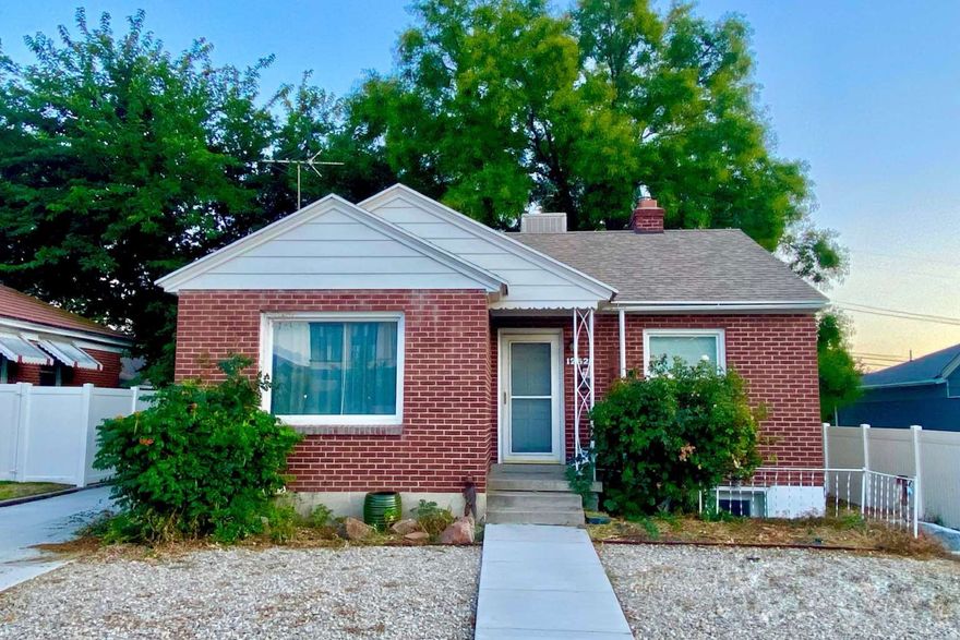 Charming Sugar House brick home with updated LVP flooring, kitchen with vintage details, 2 bedrooms, and fully remodeled bath on main level. Filled with natural light and showcasing original 1940s character blended with modern updates. Lower level features private entrance, kitchen, remodeled bath, 1 large bedroom + flex room, and separate furnace & meters-ideal for multi-generational living or rental income. Large 2-car garage, extended driveway, big vinyl fenced yard with mature landscaping.