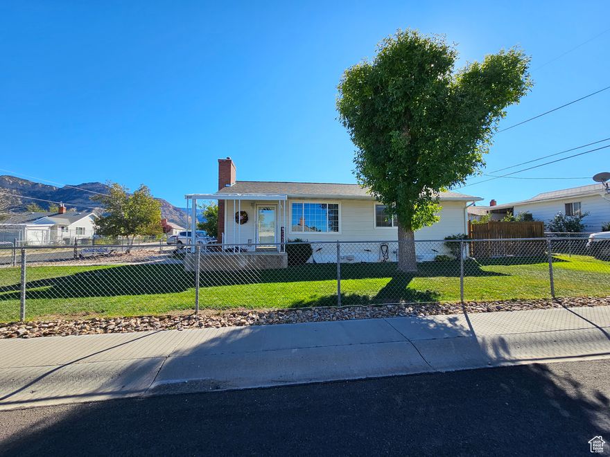 Double lot .26 lot 1c-0437-0000 included'--Charming 3-Bedroom,  single level living. The home features a large extortionary modern walk-in shower, with seating. a sprinkler system, and a recently updated roof This beautifully maintained 3-bedroom, 1-large bath home is nestled on a spacious corner lot in the peaceful town of East Carbon. Situated on a rare double lot, this property offers ample outdoor space and a massive 3-car garage-perfect for vehicles, tools, or even a workshop. Inside, you'll find a well-kept and inviting interior that suits everyone-from singles and retirees to growing families.  Family room fire place for cozy evenings. Enjoy the quiet lifestyle East Carbon offers, with hiking trails and off-road adventures right in your backyard. This is small-town living at its best-comfortable, scenic, and full of opportunity.