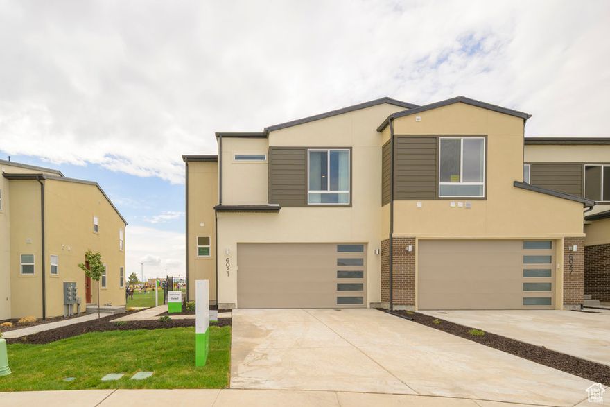 FINAL OPPORTUNITY  DON'T MISS OUT! Here's your chance to own the rare, professionally designed Garbett Homes model that has inspired countless buyers! This stunning end-unit townhome backs to an open field near a school and comes fully loaded with premium upgrades-all appliances included (washer, dryer, and fridge), custom designer window treatments, and extra windows that fill the home with natural light.  Enjoy spacious bedrooms, an unfinished basement ready for your personal touch, and a two-car garage offering plenty of parking and storage. Perfectly located near Jordan Landing, you're just minutes from shopping, dining, parks, and top-rated schools-with quick access to Bangerter Highway for an easy commute, only 15 minutes to the airport and 20 minutes to downtown Salt Lake City.  Built with Garbett's cutting-edge, energy-saving technology, this home offers lower utility costs and a healthier, more comfortable lifestyle. And best of all-it's completely move-in ready.  Call today for details before this incredible opportunity is gone.  Don't wait- Garbett Homes is offering buyers up to 2% on select ready-to-move-in homes for a limited time!