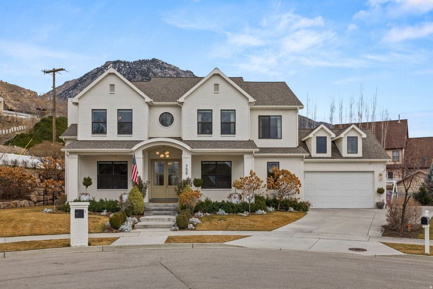 Located in the hills of Provo on a quiet cul-de-sac, this 6-bedroom, 5,000 sq ft residence sits on a rare .53-acre lot with unobstructed mountain views. The setting offers privacy and space while remaining minutes from shopping, dining, and everyday amenities, as well as a nearby park with pickleball courts. Designed for both daily living and entertaining, the main level features a spacious, light-filled kitchen with generous prep space and gathering areas that flow seamlessly together. Custom cabinetry throughout the home provides substantial storage and a clean, tailored finish. The fully finished basement includes a newly built custom playhouse and additional flexible living space. A unique opportunity to own a half-acre property in one of Provo's most desirable hillside neighborhoods.