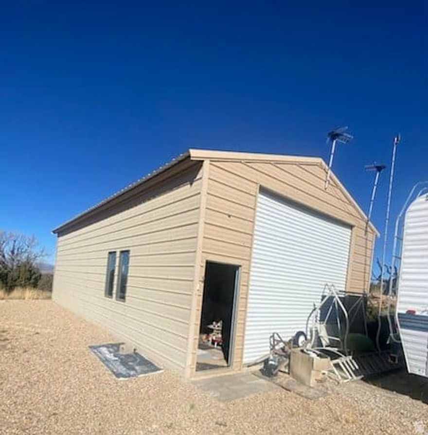 Perfect for multi-generational and multi-friends and family camping!! You could also live here year 'round. 10 wooded, peaceful acres just east of Fruitland with a panoramic view of The Wasatch AND The Uintas!! Many cleared parking spots for campers and camp trailers!  A couple of camp trailers and camper shells included.  One camp trailer is inside the shop for a "Barndominium!"  (The camp trailer right beside the shop is excluded from the purchase.)  There is a well, septic, and power.  Seller is the heir and is unsure of the status of the septic system. There is also a chemical toilet.  The well also may need some help.  There are many building materials and tools, some of which will be left behind for you! Part of the property is low and has a seasonal creek running through, making it really great habitat for deer, elk, and other wildlife! At this price, the property is to be sold in "as is" condition.  It is a good price for a great place!  Easy to show!  Call us today!