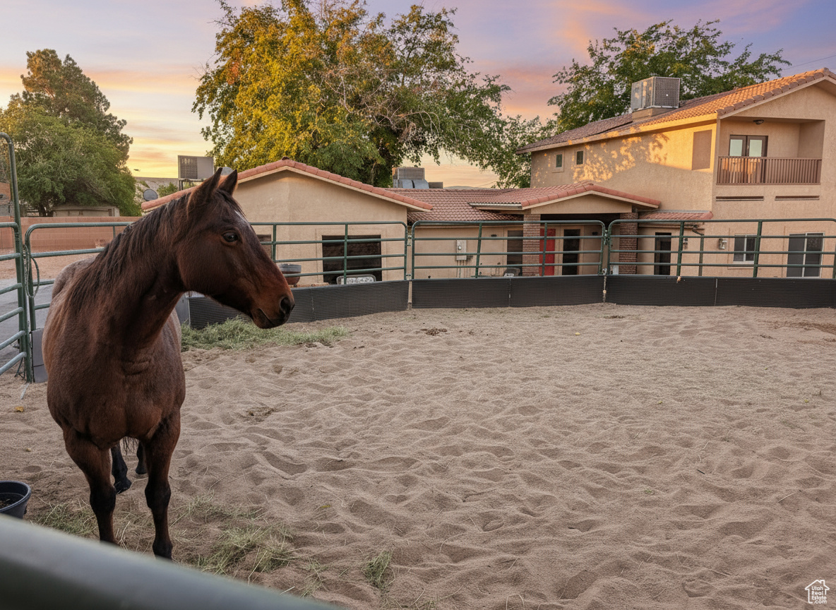 Horse Haven Ranch is an equestrian's utopia! This turnkey abode has flourished as a horse B&B under its current owners, who crafted an immaculate and peaceful equine sanctuary. Every detail of the property reflects thoughtful enhancements. The premier 15' raised center aisle barn, 2160 sf, boasts approximately $100,000 in bespoke upgrades, including world-class Stable Comfort (like WEC) orthopedic flooring (no need for shavings!) cooling misters, high-efficiency fans, awnings, shades, and a swamp cooler for those warm summer days. Illuminated stalls, a hot/cold wash bay, a bathroom, and Prodex insulation elevate the barn's functionality and charm. In the 38-foot round pen and 20x24 runs, the footing is pristine washed sand. The newly constructed garage (2022), crafted by Mancave, features 10-foot doors and an elevated ceiling height. The 2025 carport is also by Mancave. For your canine friends, a dedicated, fully enclosed dog retreat boasts a generous shaded patio and premium, professionally installed turf-a $20,000 enhancement. The 2700 sf, four-bedroom, two-bath residence is graced with beautiful appointments, a gourmet kitchen with a professional-grade refrigerator and freezer, stainless appliances, and granite counters, custom cabinetry, solid wood doors throughout the home, a luxurious primary suite, all with serene views over the horses or to the red-rocked mountains beyond. The second primary suite, on the main level, is straight out of a magazine! With its private entrance, dedicated office, gorgeous kitchenette, hardwood floors, and cowboy curated finishes, it's the quintessential retreat for in-laws or guests. Nestled in a vibrant equestrian community, Horse Haven Ranch is a short ride from some of the best trails: Snow Canyon, Rim Trail, Turtle Wall, Chuckwalla, and other trail loops. This ranch's meticulous, low maintenance design means more time in the saddle! Owners recently converted the property to sewer. All information and measurements are provided as a courtesy; buyers should verify all measurements and zoning.