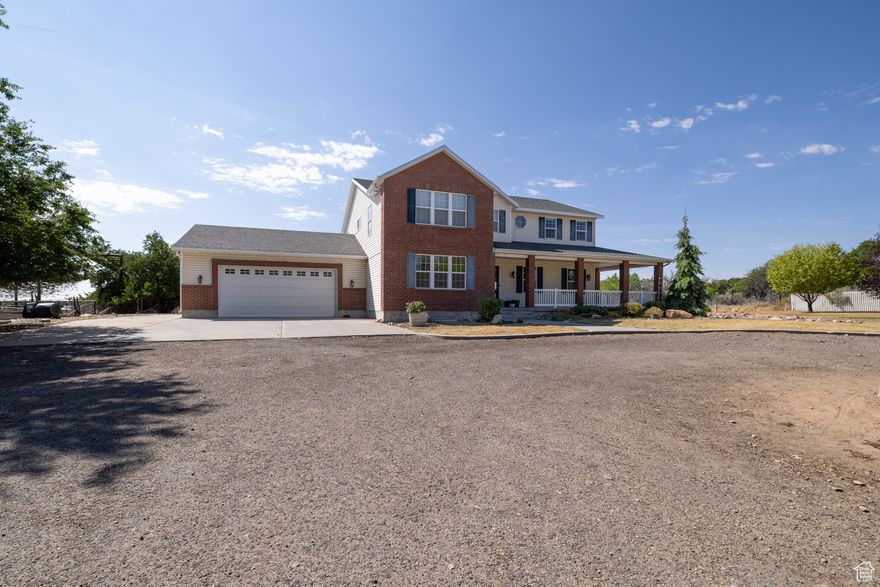 Spacious 7 Bedroom Home with Rental Potential and Pickleball court on 3 acres in Maeser! Discover this impressive two-story residence offering 7 bedrooms and 4 bathrooms, thoughtfully designed to accommodate large families or multi-generational living.  Situated on 3 acres in the desirable Maeser location, this property provides ample space both inside and out.   The home features a welcoming front wrap-around porch and a convenient circular drive, creating both charm and functionality.   Inside, the floor plan is functional and versatile, highlighted by a fully finished basement with a private entrance, ideal for use as a rental unit guest suite, or Airbnb opportunity. Outdoors, the property is well equipped with ample water shares (10 Ashley Central S Stock, 1 Ashley Valley Reservoir, .18 Primary Ashley Central Primary), a wheel line, and a pickleball court for recreation.  While the lawn has dried due to a broken sprinkler line, it can easily be revived once repaired, restoring the yard to its full potential and enhancing the beautifully landscaped grounds. With room to grow and a location that combines rural charm with convenient access to town amenities, this property presents an exceptional opportunity for buyers seeking space, utility, and long-term value.   Square footage figures are provided as a courtesy estimate only.  Buyer and Buyer's Agent is advised to obtain an independent measurement.