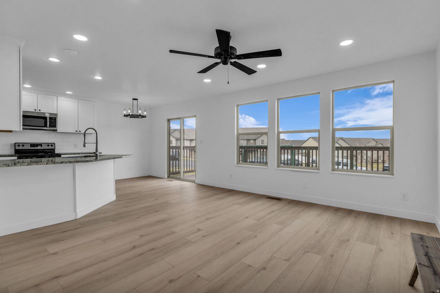 Beautifully updated 4 Bedroom 3.5 bath townhome with fully finished basement that can be used as the 4th bedroom, additional great room, media or exercise room.  This home is located in a great location with major national outlets (Lowes, Walmart, Home Goods, etc.) and national chain restaurants within 5 minutes.  New paint and flooring throughout the home and several new windows throughout the home.  The kitchen features granite countertops, SS appliances including the fridge, range, built-in microwave and a new dishwasher.  There's a huge deck off the back of the home with views of the valley, mountains and lake, plus views from the upper bedrooms of the mountains and valley.  Convenient 2-car garage that keeps your vehicles safe and out of the weather and opens to the kitchen area so when you're bringing in the groceries it's easy.  The owner's suite features a spacious bathroom, spacious owner's bathroom with a jetted tub/shower combo, double basin vanity and huge walk-in closet.  Many new lightings and plumbing fixtures have been added to the home.  This is a well built and updated home.  Don't forget the playgrounds the HOA has.  One is right out from your back deck that makes it easy to entertain the wee ones.  As an owner of a home in Spanish Fork, you can join the new Spanish Fork Rec Center that opens December 15th with indoors and outdoor pools, weight room, pickleball and B-Ball courts, indoor track, several training classes and more.   Square footage figures are provided as a courtesy estimate only and were obtained from Utah County Records.  Buyer is advised to obtain an independent measurement.