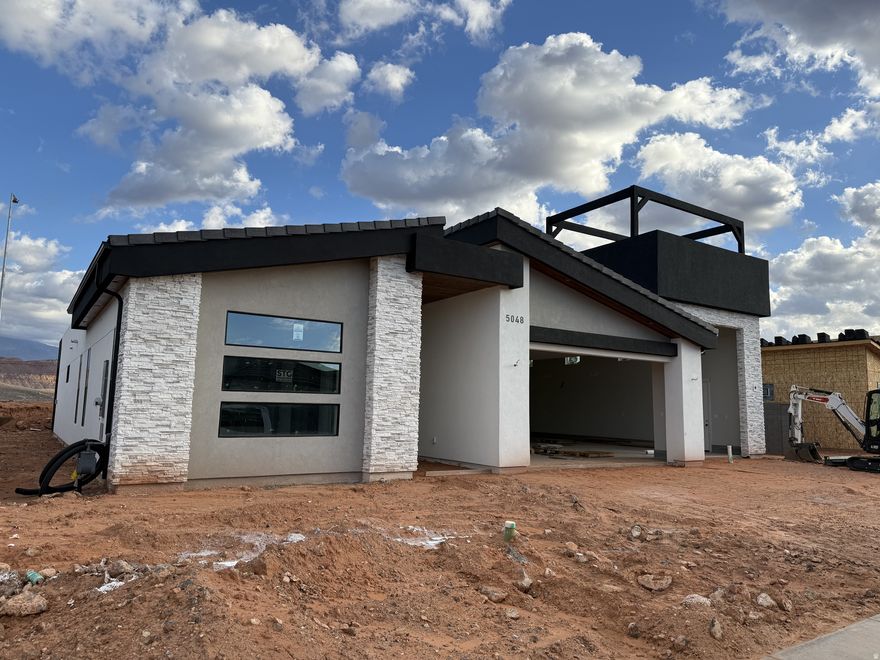 Experience modern desert living in this stunning contemporary home. Designed with open spaces and natural light, the great room seamlessly connects the kitchen, dining, and living areas, showcasing views from every angle. This 4-bed, 3-bath layout includes a private casita with its own kitchenette and bath, perfect for guests or Airbnb rental income. Enjoy a spacious primary suite with a walk-in closet, a large covered patio for outdoor living, and a 4-car oversized garage with an RV bay. Featuring sleek low-pitch roofs, stucco with wood and stone accents, and clean modern lines, this home blends luxury, function, and style in the heart of Southern Utah. Not all photos are of this home.