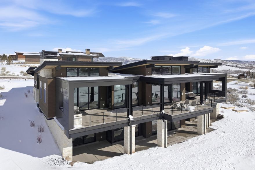 Layers of luxury live in every square inch of this extraordinary custom home, nestled in the most peaceful enclave of Tuhaye's Whispering Hawk neighborhood. Perfectly positioned above the 15th fairway, a serene pond, and open space, this residence captures mountain and water views along with expansive big-sky vistas. Thoughtfully designed and meticulously crafted, this home was built as a personal masterpiece where every finish, fixture, and feature was selected with intention resulting in a rare blend of warmth, refinement, and livable elegance seldom found at this price point. The main-level living centers around an exquisite Primary Suite retreat, complete with a plaster-surround fireplace, dual custom closets, heated bathroom floors, infrared wellness sauna, and private covered hot tub -- your own spa sanctuary after a day on the slopes or the course. Throughout the home, distinctive design elements elevate the experience: imported marble and stone, forged metal accents, artisan lighting, electric blinds, bespoke plumbing fixtures, tongue-and-groove wood ceilings, and not one, but two beautifully appointed wet bars. Created for gathering, the expansive dining area flows effortlessly into the oversized and fully equipped bar area -- an entertainer's dream for evenings filled with conversation, laughter, and celebration. The walk-out lower level is equally impressive, offering a grand TV and billiards lounge with custom ping pong table and a second wet bar featuring dishwasher, ice maker, microwave, and beverage refrigerators. Three additional bedroom suites, a powder room, and laundry ensure guests enjoy privacy and comfort. An oversized garage includes EV receptacles and even a luxury dog wash. Experience Tuhaye: championship golf course, a 9-hole short course, tennis and pickleball courts, pools, fitness facilities, and multiple dining venues. Enjoy skiing from the private Tower Lodge at Deer Valley's Empire Pass. FULL TALISKER MEMBERSHIP INCLUDED