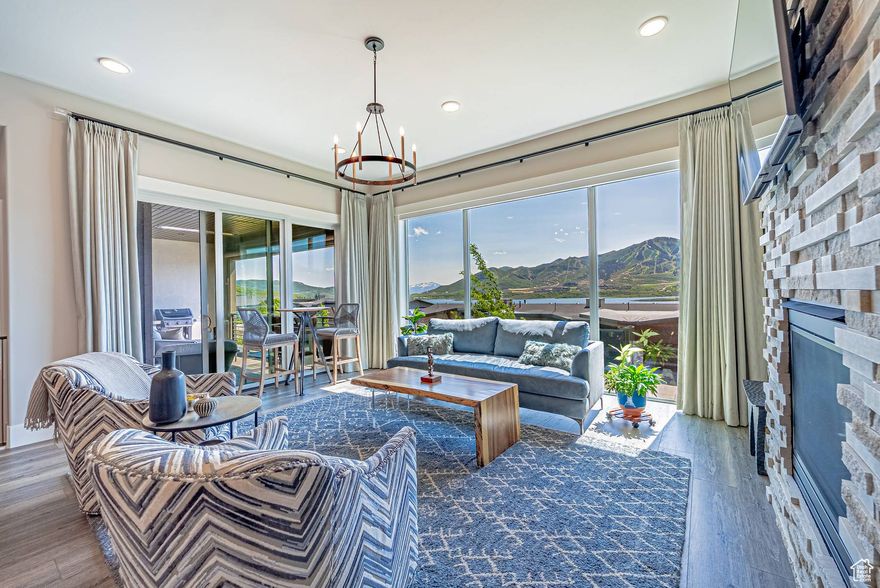 Experience mountain living at its finest in this three-bedroom home, where morning light fills every room and expansive Deer Valley East Village views serve as your daily backdrop. The main level centers on a serene primary suite with generous windows that frame the ski runs and flood the space with fresh air. Entertain or unwind in the open living area, where a thoughtfully designed kitchen features sleek countertops, stainless-steel appliances, and a spacious island-perfect for casual breakfasts or hosting friends. The bonus area offers flexibility as a home theater, workout space, or creative studio. When it's time to enjoy the outdoors, step onto the oversized deck or private patio and take in the ever-changing mountain scenery-from sunrise's soft glow to evening's warm hues.  This meticulously maintained residence feels new, with premium flooring, electric blinds, and custom lighting elevating everyday life. The two-car garage is outfitted for easy storage and organization, and elegant finishes lend a refined touch at every turn.  Ideal for anyone seeking a property with effortless style, this home pairs convenience-two-car parking, generous living areas, and a main-level master-with the calming presence of outdoor adventure just beyond the door. Imagine weekends spent on the slopes, afternoons paddleboarding nearby reservoirs, and evenings gathering beneath a star canopy.  Make this elevated mountain retreat your own-schedule a private showing today.