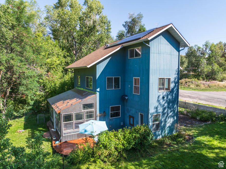 Welcome to your own secluded sanctuary-this inviting three-story, single-family home is on approximately 1.59 acres of peaceful, rural landscape with a year-round creek.  Inside, the spacious home offers 2580 +/- sq ft, featuring 4 bedrooms and 3 baths, office/den, vaulted ceilings, an open-style layout, and an updated kitchen boasting stone countertops, large pantry storage, and unique vintage accents-like a homestead butcher block, reclaimed barnwood pieces, and an antique door from Inkom's original city hall.  The master suite is a true retreat, offering a spacious layout, a cozy sitting area, and an ensuite bathroom. Outdoors, the property is beautifully landscaped with mature trees, diverse shrubs, an orchard, and garden space. Additional amenities include: a sunroom, multiple outbuildings (including one with a charming playhouse above), a large walk-in crawlspace/cellar, and a shed. Home also has a solar power system boasting energy efficiency and sustainability. Adventure enthusiasts will appreciate the easy access to nearby skiing and hiking.  This is the perfect permanent residence or vacation home. Call your favorite agent for a tour today!