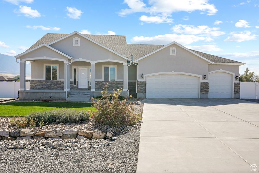 Welcome to your dream home in beautiful Lake Point! With over 3,700 sq. ft., this rambler sits on just over one acre, perfectly suited for horses and outdoor living in a quiet secluded cul-de-sac. Enjoy peace and privacy surrounded by breathtaking mountain views and unmatched sunsets over the Great Salt Lake. Step inside to find an open floor plan with a main-level primary suite, two upstairs bedrooms and laundry for easy single-level living. You'll also love the large walk-in pantry, vaulted ceilings, beautiful custom cabinetry, and the gorgeous granite countertops and sink. The semi-formal dining and formal living room are perfect for guests and entertaining. But what you may love most is the ceiling heating lamps in the primary suite! You will truly love all the amenities this home has to offer. Downstairs the basement is completely finished with a theater room, more living space for entertainment, a home gym, three additional bedrooms, a bathroom and tons of storage. In fact, the cold storage runs the width of the home! Car enthusiasts and hobbyists will love the huge garage which can house 5 vehicles (currently two spaces in the garage have been converted to a heated workshop with a 220v outlet offering plenty of space for projects year-round). Outside, there's endless room to park your boats, RVs, ATVs, or trailers. You'll also find a generator hook-up and electric outlets in the backyard. Whether you're enjoying quiet evenings on the patio, watching horses graze, or taking in the panoramic views, this property offers everything you could ask for with loads of rural charm--all just minutes from Salt Lake City conveniences. Square footage figures are provided as a courtesy estimate only and were obtained from building plans. Buyer is advised to obtain an independent measurement.