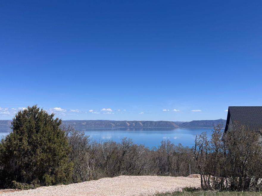 AMAZING BEAR LAKE VIEW LOT!! Located at the top of Bear Lake West Main Sub (Utah/Idaho border) on Calamity Dr, this lot has panoramic views of Bear Lake, surrounding mountains and valley and borders BLW common area/Caribou National Forest to the west. Year round access and Bear Lake West amenities--Cooper's Restaurant and Sports Bar, Bear Lake West Golf Course, tennis and pickleball courts, heated pool (seasonal), hot tub (year round), gated beach access to Bear Lake. Bear Lake State Park Marina (boat launch, watercraft rentals) and Garden City (shpping, dining) 10 min; Beaver Mountain Ski Resort (skiing, mountain biking) 25 min. No short term rentals allowed per HOA.