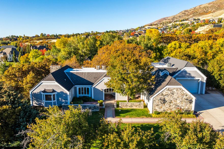 A truly one of a kind private estate located on Farmington's East bench. 388 Quail Run Rd is tucked away in a quiet neighborhood and sits on 4.869 acres of privacy, peace, and possibility. The home is placed on 2 separate parcels, with the residence spanning over 10,500 Sqft. Vaulted ceilings, 2 kitchens and a primary suite that is a retreat of its own - complete with a fireplace, sitting area, and an oversized walk-in closet. Inside you will feel radiant floors, and the natural light spread across the 6 bedrooms, and 6.5 bathrooms. Throughout the home there are a variety of gathering spaces, one that could be a theater, home gym, or sport court. Car enthusiasts will appreciate three garages, including two oversized 24'  56' bays with 12' doors - large enough for RVs, boats, or an impressive car collection. Heated garages and driveways are all part of this one of a kind property. The real jewel of this estate is the tranquility that is something you can only dream of. The backyard has been transformed into your own private park. A lush, tree-lined yard with playhouses, an in-ground trampoline, a basketball court, and swing set invites endless play, privacy and relaxation. On quiet mornings you will be greeted by deer and other wildlife that occasionally wander through the grounds. Set just minutes from Farmington Canyon's trailheads and top-rated schools, this property balances the best of private living and modern convenience. This is more than a home - it's a legacy estate that cannot be duplicated and must be seen to truly appreciate.