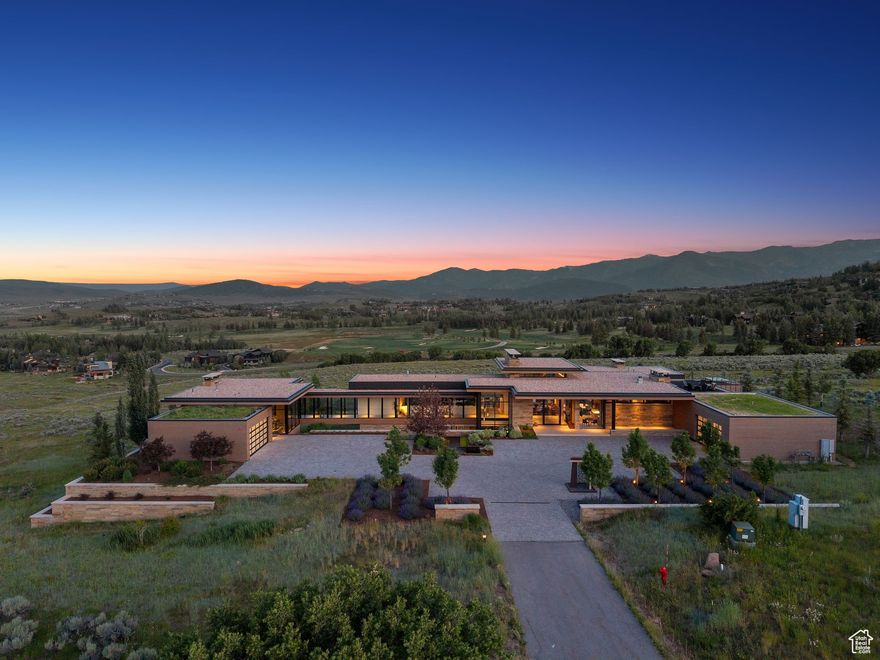 For the first time ever, one of the most significant and irreplaceable legacy properties is available. Set on over 40 private acres, this trophy estate sits within the exclusive, gated community of Glenwild-home to one of Utah's top ranked private golf courses-offering unmatched privacy, scale, and panoramic beauty that simply cannot be replicated. Perched above the Glenwild Golf Course and showcasing sweeping, unobstructed views of the entire Wasatch and Uinta Mountain Ranges and world-renowned Park City ski resorts, this architectural masterpiece is a rare convergence of location, design, and exclusivity. Designed by the acclaimed Upwall Design Architects and brought to life by Sapp Development Group, every detail of this modern estate has been crafted to the highest standards of luxury. The home's striking modern architecture, custom finishes, and refined landscaping and water feature create a living experience that is both bold and harmonious with its natural surroundings. Featuring main-level living with an open floor plan and a true chef's kitchen, as well as a fully- equipped guest house connected by a glass-enclosed bridge, this estate was thoughtfully designed for comfort and functionality. From your own property, access a network of hiking and biking trails, drive your golf cart to the Glenwild clubhouse or simply take in the endless vistas from your outdoor entertaining areas. Located just 10 minutes from Kimball Junction and 20 minutes from Historic Main Street in Park City, you're never far from world-class skiing, fine dining, boutique shopping, and vibrant nightlife-yet worlds away in terms of peace and seclusion. Other amenities include multiple wet bars, Sky-Frame automatic sliding glass doors, sunken media room, fitness room, game room, wine cellar, exterior built-in bbq, and garage space for four cars. This is not just a home-it's a generational opportunity to own a once-in-a-lifetime estate in one of the most sought-after mountain communities in the country. A landholding of this scale, with these views and this pedigree, is truly unmatched in today's market.