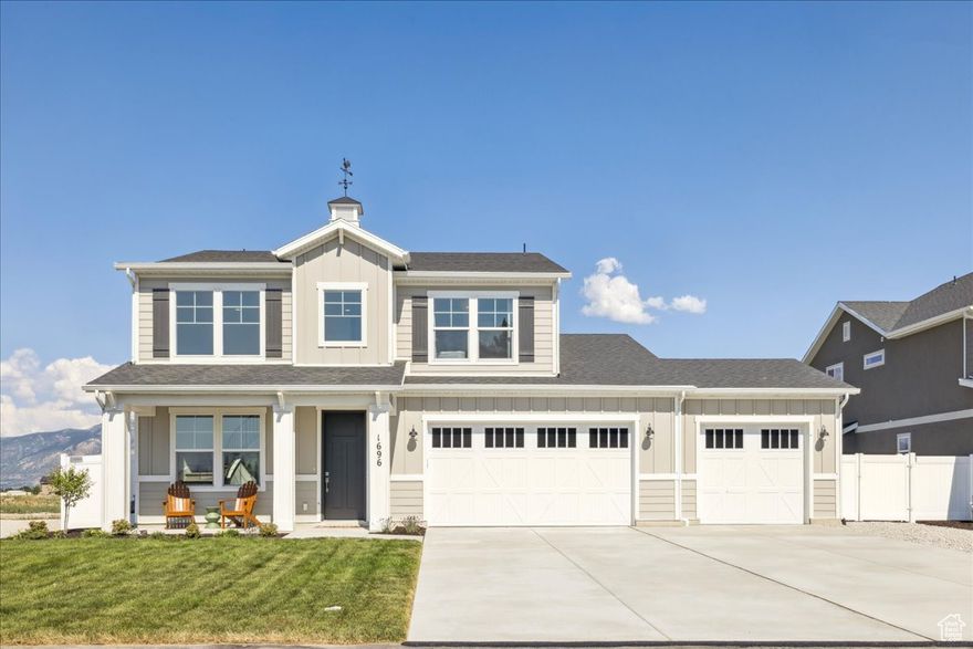 This home was recently featured in the 2025 Parade! The Cotham floor plan welcomes you with timeless elegance and thoughtful design. A covered porch opens to a grand two-story entry with a curved stair case, creating a stunning first impression. The main level features a private office and a beautifully designed kitchen with a spacious walk-in pantry. The expansive primary bedroom serves as a serene retreat, complete with a luxurious walk-in closet. Home has a large  finished 3 car garage attached and in the backyard you will find an additional completed toy car garage. The avid weekenders dream for boat, Razor, Dirt bikes etc. Situated in picturesque West Weber, this home offers a harmonious blend of privacy and convenience, with modern amenities just moments away.