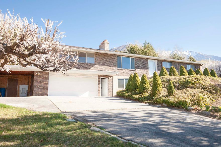 Nestled in the heart of Lindon, this spacious 5-bedroom, 2.5-bath home offers over 3,172 square feet of opportunity, charm, and incredible potential. Situated on a rare and expansive 0.51-acre lot, the property provides endless possibilities whether you're looking for room to entertain, expand, or simply enjoy wide-open space. Inside, you'll find a functional and well-designed layout with multiple living areas, and great natural flow throughout. The home is "as is" and priced to sell. This is an incredible location. Enjoy breathtaking mountain and lake views right from your property. The oversized lot offers ample space for entertaining, gardening, and future improvements. This is located in one of Lindon's most sought-after neighborhoods, this property combines space, location, and potential.