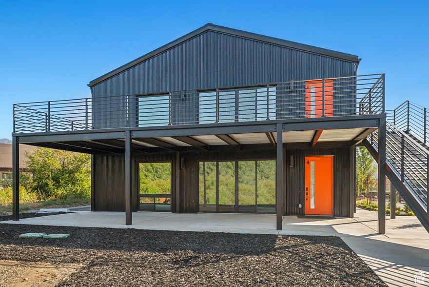 New building located in the heart of Eden's Business District. Zoned CV2. Clad in black corrugated steel, this building is filled with abundant natural light, has stunning mountain views, and was designed in a sophisticated Hygge Style. As you walk across the expansive patio and into this upper level apartment you will be inspired by the bright openness of this space. You will be in awe as you look out towards Nordic Ski Resort, Ben Lemond Mountain, and you'll even be able to see Pineview Reservoir off in the distance. Cozy up in the living room with its gas fireplace. The modern kitchen will be your perfect spot to make breakfast and your morning coffee. Stacking washer and dryer are an additional convenience with-in the unit. There is even a loft space that could be a fab reading nook, with supplemental storage closets. There are two bedrooms, one with an ensuite bathroom. Large format tiles add to the modern flare of the bathrooms. All rooms have mini-split HVAC systems.  *** This property has 4 units.  The MLS reference numbers are Unit A (Upper Level Apartment) #2026048, Units A/B/C (commercial listing for the black building) #2025570, and the house #1981550.