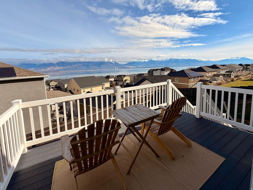 Just appraised at $655,000, this stunning open-concept 6-bedroom, 3-bath home captures panoramic lake and mountain views while blending modern design, smart-home technology, and thoughtful luxury throughout. The kitchen features quartz countertops, stainless steel appliances, and built-in Bluetooth speakers that carry sound throughout the upper level. The living room features a cozy gas fireplace, perfect for relaxing or entertaining with expansive views. Smart-home upgrades include a wired Nest system, smart porch lighting, a Ring doorbell, and five exterior security cameras. The fully finished walkout basement with a separate entrance, kitchenette, laundry hookups, 8-foot ceilings, and sound-dampening insulation is ideal for guests, multigenerational living, or potential rental opportunities. Washer/dryer hookups on both levels add everyday convenience. Outside, enjoy a 3-year-old Bullfrog R-Series hot tub (seats 6), a fire pit, a fully irrigated garden, and beautifully landscaped grounds with rock accents. A newly finished 10'x12' shed with electrical provides versatile storage or workshop space. The community offers playgrounds, BBQ areas, walking trails, picnic spots, and pet-friendly amenities. Buyer to verify all.