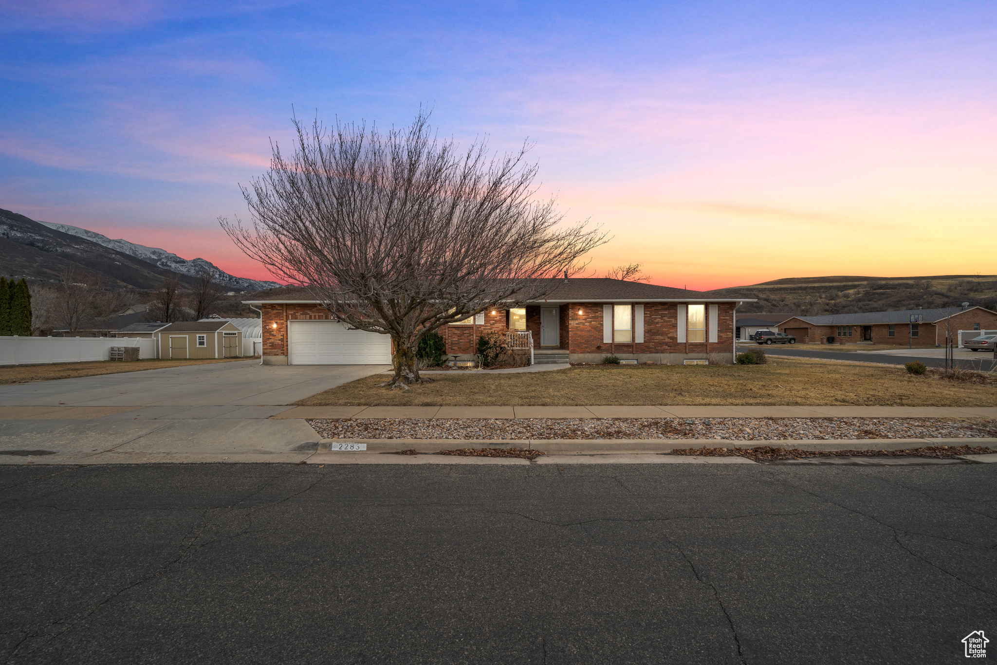 Discover the charm and comfort of this Rambler-style home, perfectly positioned on a large 0.39-acre corner lot in beautiful South Weber. This two-owner property has been thoughtfully updated and boasts an expansive 3,304 square feet of living space, featuring 5 bedrooms, 4 bathrooms, and multiple living areas that cater to all aspects of family life. The heart of this home is its open kitchen, complete with stainless steel appliances, a functional center island, and elegant granite countertops. The main floor features a master suite, complete with an ensuite bath, two additional bedrooms, and bathrooms. Venture downstairs to find a spacious family room, two large bedrooms, a fully remodeled bathroom, and beautiful new kitchen. With its own separate exterior entrance, the lower level is ripe for conversion into a separate basement apartment, offering privacy and convenience. Storage is abundant throughout, with multiple closets, cold storage, and a large shed in the backyard. The attached garage is extra deep, providing ample space for a workshop or additional storage. RV parking is also available along the side of the garage. Enjoy magnificent views of the Wasatch Mountains from this prime location, ideally situated between Davis and Weber Counties. Quick access to Highway 89 and I-84, and a mere 10-minute drive to Hill Air Force Base, adds to the allure of this property. This home represents an exceptional opportunity to own in one of South Weber's most desirable neighborhoods. Contact me today for a private viewing and experience firsthand the unique blend of luxury, location, and lifestyle this home offers.