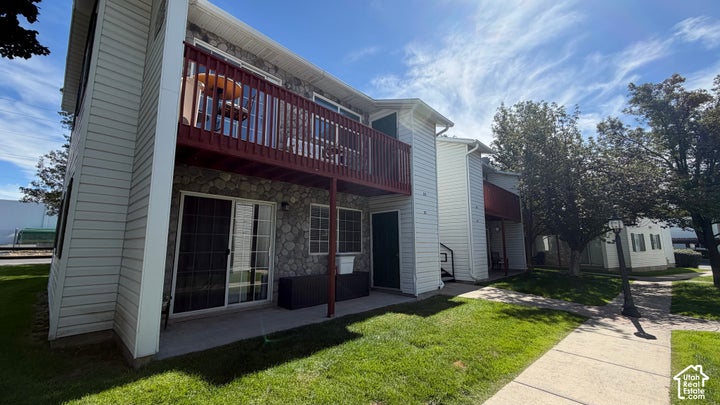 Stone veneer and horizontal siding exterior with a second-story balcony