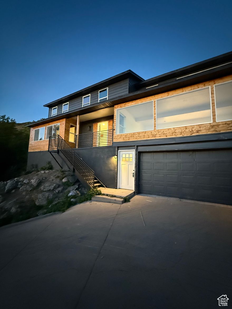 No showings until the grand opening, Wed. Aug. 13  Perched on a picturesque hillside, this beautifully updated 5-bedroom, 4.5-bath home offers sweeping, unobstructed views of the valley and some of the most breathtaking sunsets you'll ever see. The dining room wall is lined entirely with windows, bringing the outside in and creating the perfect backdrop for memorable meals.  Upstairs, you'll find an ideal layout for families with four spacious bedrooms and two full bathrooms on the same level. The heart of the home features a massive kitchen where you can gather with loved ones and take in the view.  The walkout basement includes a bedroom, bathroom, and two additional living spaces-perfect for entertaining, guests, or even a potential accessory dwelling unit (just add a stove and refrigerator).  Situated on over half an acre, the yard is landscaped on the first two levels, with plenty of parking for family and friends. This home combines space, functionality, and style in one stunning package-fully updated and ready for you to move in and make it your own.