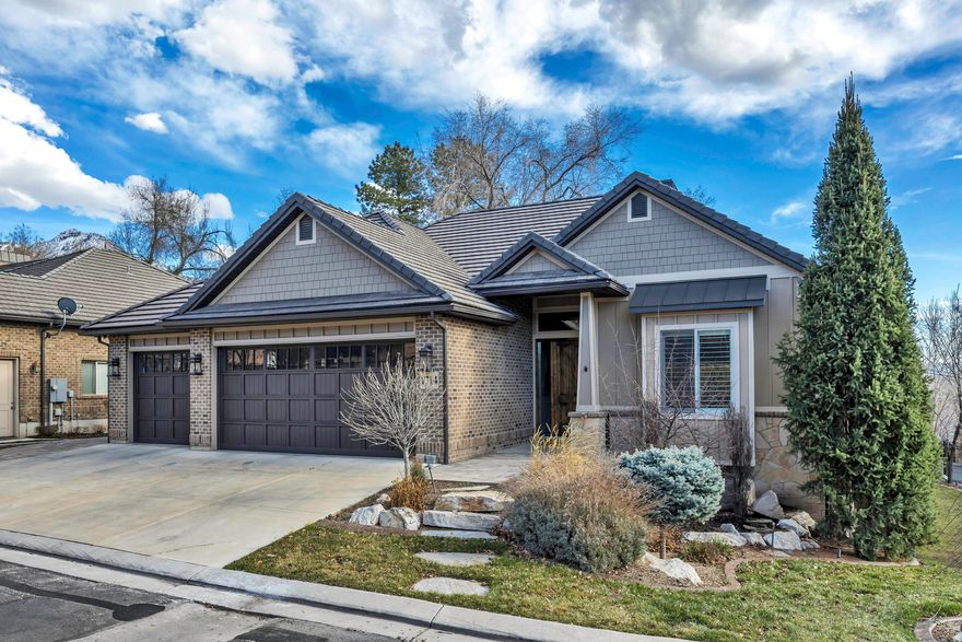 This gated, timeless home in the heart of Holladay is filled with natural light, soaring 12-foot ceilings, quality finishes, and high-end features throughout. The main level is designed for effortless living, featuring a main-floor primary suite and open gathering spaces ideal for both everyday living and entertaining. The lower level offers 10-foot ceilings and over 3,000 square feet of finished living space, including a fully equipped gym, a future golf simulator setup, wet bar, generous storage, and flexible space to fit your needs. Step onto the covered deck and take in peaceful, tree-lined views with no backyard neighbors that offers a level of privacy that's hard to find. Designed as a true extension of the home, the outdoor living space functions as a second family room, perfect for year-round enjoyment. Located within a gated community just off Highland Drive, this home offers an ideal balance of privacy and convenience. Enjoy quick freeway access with easy connectivity to downtown Salt Lake City, SLC  International Airport, and the nearby Big and Little Cottonwood Canyons, as well as Parleys Canyon, providing year-round access to skiing, hiking, and outdoor recreation.