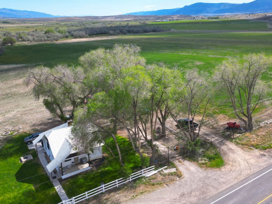 Discover a rare opportunity to own 60.13 acres of scenic Utah countryside where the beautiful Sanpitch River winds gracefully through the property, creating a peaceful setting rich with wildlife, open space, and endless possibilities. This exceptional Mt. Pleasant ranchette combines productive farmland, breathtaking views, and comfortable rural living all in one remarkable property. The 2,016 sq. ft. home offers country charm with modern comfort, perfectly positioned to enjoy panoramic mountain and valley views in every direction. Whether you're looking for a working farm, horse property, recreational retreat, corporate retreat, air bnb, or private homestead, this property offers the versatility to fit your vision. Included are 61.50 irrigation water shares through the McArthur Frandsen Ditch Company along with three wheel lines, providing valuable water resources for farming, ranching, or pasture use. The river corridor attracts abundant wildlife year-round, including deer, wild turkeys, and seasonal elk, creating an incredible natural backdrop right outside your door. Properties offering this combination of usable acreage, irrigation water, river frontage, wildlife, and a move-in-ready home are increasingly hard to find. Experience the beauty, privacy, and lifestyle that country living in Mt. Pleasant has to offer.  Square footage figures are provided as a courtesy estimate only and were obtained from county records. Buyer is advised to obtain an independent measurement.