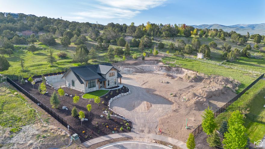 Unique Opportunity to utilize your fully finished detached ADU (accessory dwelling unit) while building your Luxury Dream Home on the rest of your 'Extreme View' 1.51 Acre Lot.  ADU is a beautiful ''state-of-the-art'' constructed space with 2063 sq ft./ 3 bedrooms/2.5 baths. Mitsubishi mini-split heating/cooling systems. LG & Bosch appliances. Polished concrete floors. Quartz counter tops. Comcast/Xfinity hard wired fiber optic internet lines. Includes all audio-visual equipment. Central Vac. Heated 45 ft deep RV garage. Heated 3 car garage w/Tesla Charging Station. Landscaped. Fully completed architectural plans for a 9,900 sq ft 'unbuilt' main house available. Full furnishings package in the finished apartment, available to acquire too.