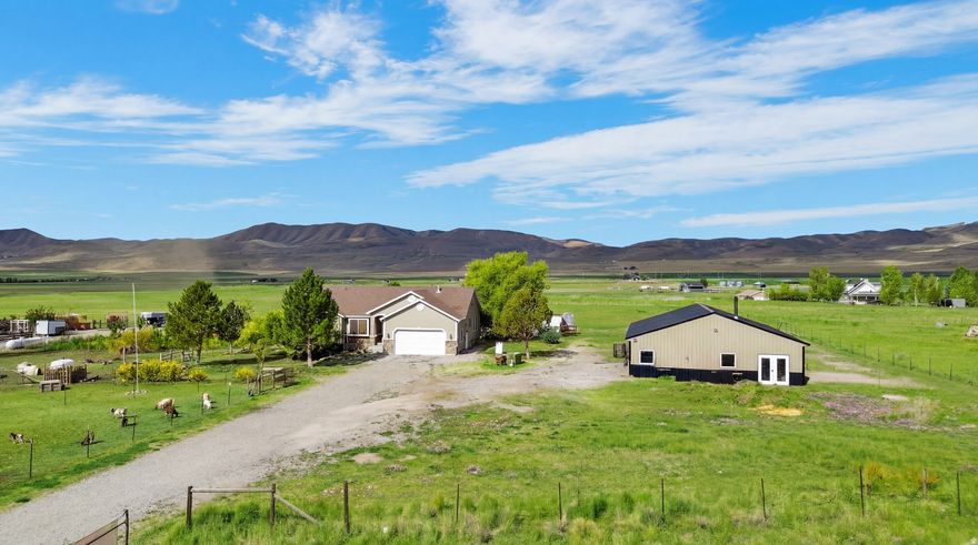 Nestled on a Sprawling 3.6-acre lot in the heart of Utah's scenic Mountains, this Charming 4-Bedroom, 3-Bathroom Home is the ultimate Retreat for anyone looking to embrace Self-Sufficiency and Outdoor Living. With Stunning Views and plenty of space to grow, this property is perfect for those wanting to live off the land while enjoying the comforts of a Spacious, Open-concept Home.   The Key Features are: 4 Bedrooms, 3 Bathrooms are Ideal for Family Living, with a layout that flows seamlessly. Fully Fenced Property that equals Peace of mind and Privacy, with room for Livestock, Pets, or Outdoor projects. 2-Car Garage & Large Shop is equipped with both water and power, making it the perfect space for Hobbies, Storage, or Working on projects. Fruit Trees & Garden Space with multiple fruit-bearing trees, including strawberries, grapes, and raspberries, await your harvest. Wood-Burning Stove, Cozy up in the winter with a reliable, off-the-grid heating source.