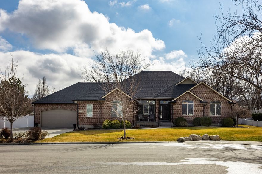 Discover a rare opportunity to own a meticulously maintained full brick rambler that has never before been offered on the market. Nestled in a serene cul-de-sac in South Jordan, this exceptional property offers the perfect blend of privacy and convenience-just five minutes from I-15, only thirty minutes to either downtown Salt Lake City or downtown Provo, and thirty minutes to world-class ski resorts.  Conveniently located within minutes of shopping, restaurants, schools, the local library, and the South Jordan Recreation Center, this home provides easy access to everything you need while maintaining a peaceful, private setting.  The main floor welcomes you with an updated ambiance that reflects years of thoughtful improvements. Quality craftsmanship is evident throughout, from the refinished hardwood floors to the custom plantation shutters and granite countertops. The primary suite serves as a private retreat, while a second bedroom features its own en suite bath-ideal for guests or multi-generational living.  The versatility of this home truly shines with its income-generating potential. A fully appointed one-bedroom basement apartment features its own full kitchen, laundry hookups, and private entrance through the garage. With nine-foot ceilings, the basement maintains an open, inviting feel while offering complete separation from the main living areas-perfect for extended family, a private home office suite, or additional living space.  Car enthusiasts and hobbyists will appreciate the exceptional garage space: a spacious four-car attached garage with extensive custom cabinetry for storage, plus a detached one-car garage/shop with RV parking-each with its own dedicated heating system for year-round comfort.  The outdoor living experience is equally impressive. The park-like yard has been thoughtfully designed with garden boxes for the green thumb, mature landscaping that provides natural privacy, and a serene patio perfect for entertaining or quiet evening relaxation.  From the 30-year architectural shingles installed in 2023 to the completely renovated bathrooms and updated mechanicals, this home has been cared for with exceptional attention to detail. Recent updates include new carpet (2025), fresh paint throughout (2025), updated lighting fixtures, and HVAC system service. This is a turnkey lifestyle property, with every major system and surface upgraded or meticulously maintained.  This is more than just a house-it's a lifestyle property offering peace, functionality, and income potential in South Jordan, Utah, along the Wasatch Front. Properties of this caliber with basement apartment income potential rarely become available. Schedule your private showing today.