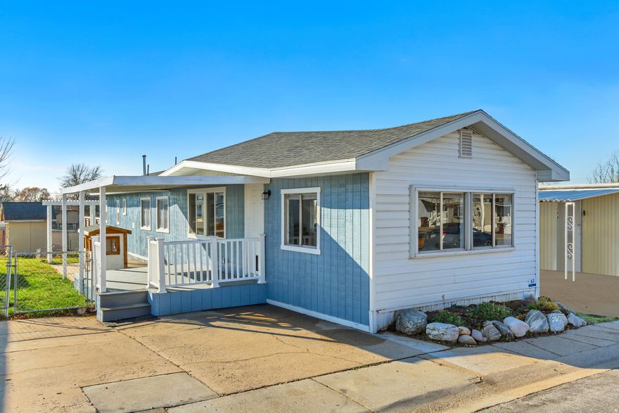 This charming, updated mobile home located at 1239 W 400 N #63 in Clearfield, UT was built in 1973. It features three bedrooms, 1 bathroom and a finished area of 960 sq. ft. It offers a cozy, comfortable living space with laminate flooring, beamed ceiling, newer kitchen cabinets, and natural light. The home has been freshly painted throughout. Updates include newer kitchen countertops, newly tiled bath, new carpet, and 25 yr. comp roof. There is ample outdoor space on the 10,000 sq. ft. lot, with a covered outdoor deck, garden space, and trees. Includes large shed for tool storage. Perfect for those looking for an affordable living option in a convenient location. Just 10 mins. to Hill AFB and 5 mins. to high school, shopping and restaurants. Walking distance to busine and elementary school. HOA paid to Sundown Homes. Requires Sundown Homes application.