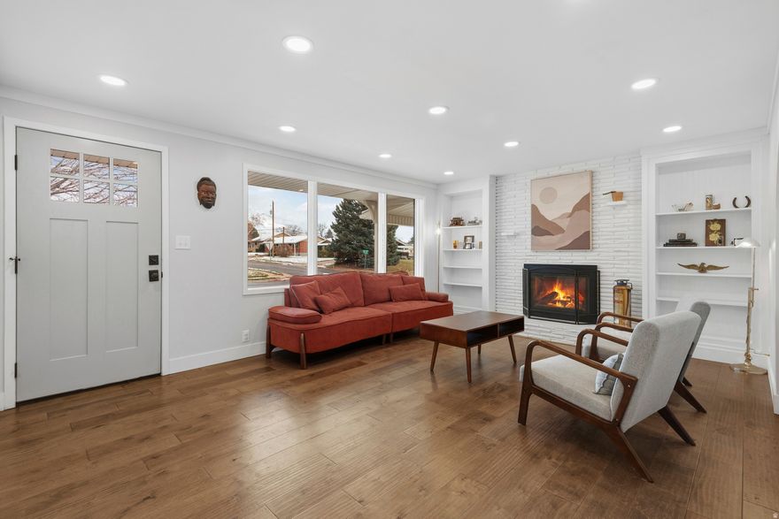 This updated brick rambler in Kaysville offers timeless curb appeal and a long list of recent improvements all completed in 2025. Inside, enjoy a refreshed aesthetic with newer flooring, two cozy fireplaces, and flexible living spaces up and down. Essential upgrades include a new electrical panel, a new gas shutoff for the dryer, relined sewer line, a pressure-reducing valve, and a water softener. Washer and dryer also included. Outside, enjoy established landscaping with white and yellow peach trees, a raspberry patch on the north side, and a well-loved strawberry bush. Professional tree trimming around power lines and the roof was completed this year, ensuring a safe and well-maintained exterior. This home blends peace of mind with comfort, offering a move-in ready experience in a beautiful, established neighborhood.