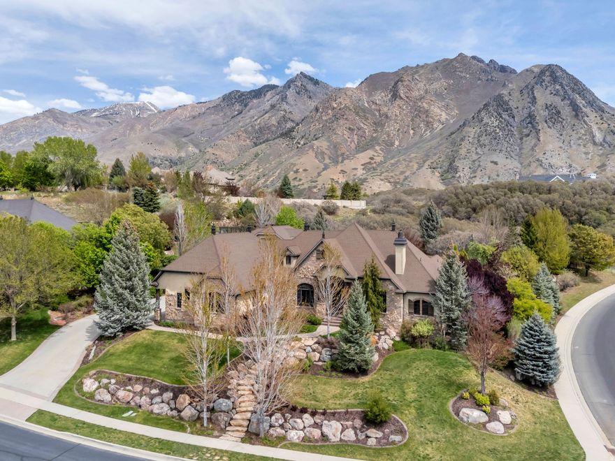 This home was crafted with meticulous intention, patience, and with a standard that is immediately felt the moment you pass through the grand iron entry doors. Soaring ceilings rise to meet intricate stonework and rich dark wood, and suddenly you understand that this home is different. The kitchen and great room open to breathtaking views. Wood beams. A fireplace. Thermador and Sub-Zero. And outside - a double waterfall cascading through mature trees and lush landscaping that feels less like a backyard and more like a private sanctuary you never have to leave. Go downstairs and discover an entire world - Ten- and twelve-foot ceilings, theater, game room, billiard room with built-in safe, a gym that flows into a private sauna, and a second kitchen. Suspended slabs. Stone and brick walls. Every detail considered. Outside, a lit sports court, detached garage for the boat and RV, and above it - a framed ADU waiting for your vision. This is the estate you pictured when you decided you were done settling. Properties like this don't wait. And neither should you.