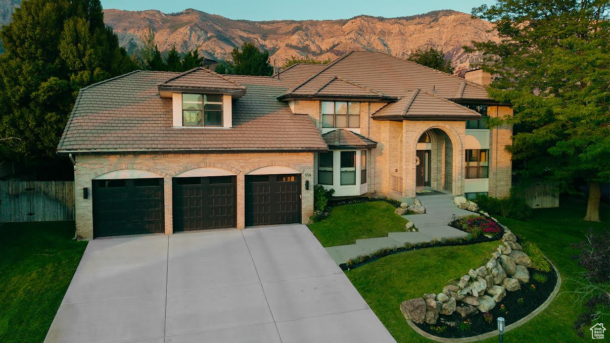 **Huge Price Improvement**Stunning Modern North Ogden Home with Versatile Living Options. Discover this remarkable 5-bedroom, 5-bathroom home, perfectly situated to offer breathtaking mountain and valley views. This residence features a modern, spacious interior with a curved set of beautiful staircases and a chef's kitchen with custom concrete countertops and 6-burner stove with griddle and double-oven ideal for culinary enthusiasts. You'll find it easy to spread out among the 5 generously sized bedrooms with walk-in closets and led lighting. Curl up and enjoy your favorite movies in the theater space with in-wall wiring for surround sound and digital projection. In the cooler months built-in secondary overhead lighting options provide a warm ambiance as you cozy up by any of the four fireplaces found throughout the home. Additionally, you can enjoy a large gym space, wall mirrors, and an abundance of natural light to maintain a healthy and active lifestyle. Another standout feature is the basement which highlights a second kitchen and can function as an apartment, offering flexible rental potential for short or long-term stays. Retreat to the primary bedroom suite, which includes a generous backlit walk-in closet and a well-appointed en-suite bathroom with an oversized soaking tub, walk-in shower and private deck. The property boasts multiple outdoor spaces, including 3 patios and 2 decks, perfect for enjoying the secluded and spacious backyard. Included in this desirable neighborhood are several community green spaces and playgrounds including a tennis court and pavilion that can be utilized by any Lakeview Heights HOA member. This beautifully renovated home combines comfort and functionality in a tranquil setting on a low traffic street. Don't miss the opportunity to make it yours!