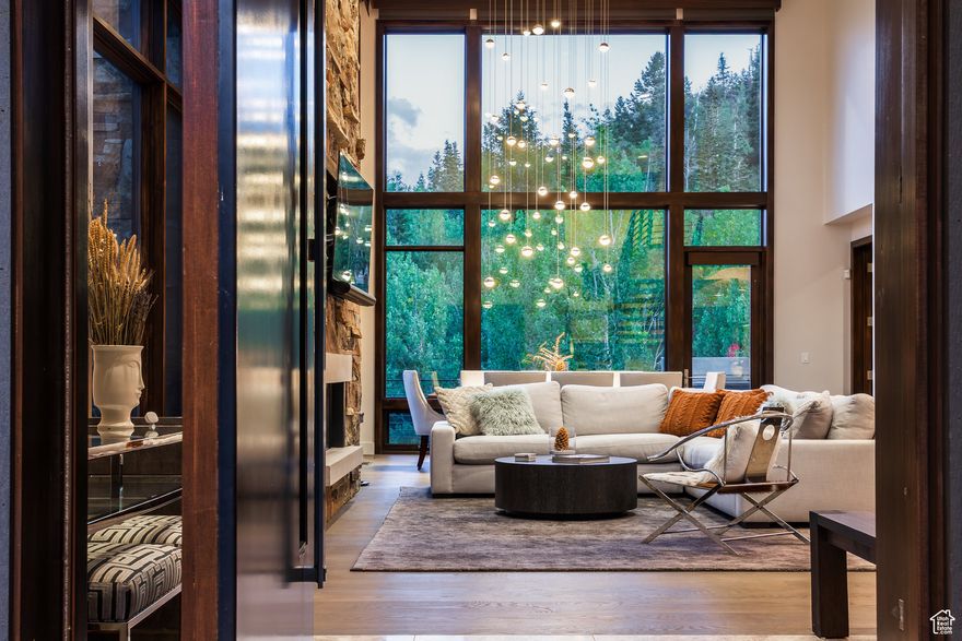 Nestled in the aspens at the Enclave at Sun Canyon, this Michael Upwalldesigned residence offers a rare combination of architectural pedigree, privacy, and seamless indoor-outdoor living. Set at the end of its row and perched above a flowing creek, the home enjoys unobstructed open space views that will remain protected for generations. Thoughtfully designed across four levels, the residence features vaulted ceilings, floor-to-ceiling glass, and multiple decks to capture natural light and mountain vistas. The main level offers a spacious great room with fireplace, dining area, chef's kitchen, and ski-ready mudroom. The upper level is dedicated to a private primary suite with sitting area, spa bathroom, and walk-in closet. The Aspen Level is perfect for entertaining with a family room, wet bar, deck access, and two en-suite bedrooms. The Creekside Level provides a private gym, lounge space, storage, and an additional bedroom. Here, every detail is designed to blur the line between home and nature, creating a sanctuary that feels both timeless and alive.