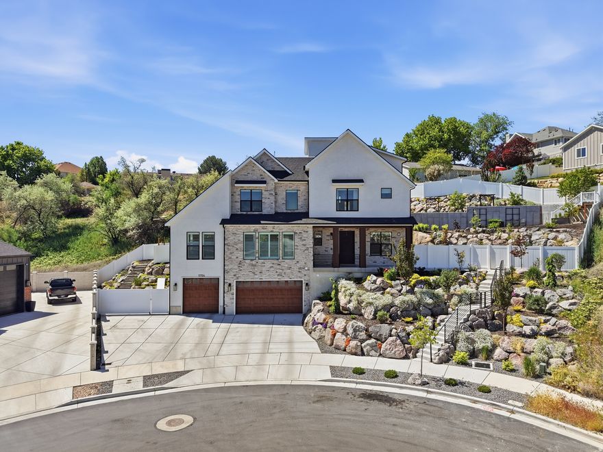 Elevated South Jordan luxury with panoramic mountain and valley views. This stunning two-story home blends refined design with premium finishes throughout-including a private elevator, stone and stucco exterior, and an oversized three-car garage.  The open-concept interior features plantation shutters, recessed lighting, and premium LVP flooring. The chef's kitchen impresses with a quartz island, white shaker cabinetry with brass hardware, professional-grade range with pot filler, and top-tier stainless appliances.  The primary suite offers a serene retreat with tray ceiling and large view windows. A rooftop deck with hot tub, turf, and string lighting delivers breathtaking views, while the terraced backyard with natural rock, patios, and mature landscaping completes this exceptional property. Square footage figures are provided as a courtesy estimate only and were obtained from County records .  Buyer is advised to obtain an independent measurement.
