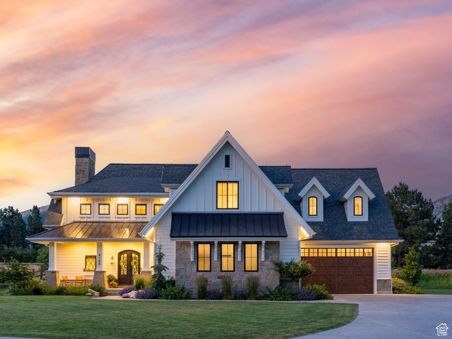 This 5-bedroom, 5-bathroom custom home delivers 6,390 square feet of living space on just under one acre inside Elk Ridge Estates, a three-member HOA in Liberty on the northwest farmlands of Ogden Valley. It is the first property ever offered to the public in this exclusive neighborhood and enjoys clear mountain views and protected open spaces. The location strikes a rare balance between country-quiet and city-convenience. I-15 and downtown Ogden lie about twenty minutes away, and Salt Lake City International Airport is roughly an hour south. Year round recreation surrounds you with North Fork Park, Powder Mountain, and Pineview Reservoir only minutes from the front door. A vaulted great room commands attention with exposed timbers, a full height stone hearth, and both wood burning and gas fireplaces. The chef level kitchen pairs white cabinetry, statement tile, professional grade appliances, designer lighting, and premium plumbing fixtures around an island that seats four. The main level primary suite offers vaulted ceilings, generous natural light, a spa style bath, and a large walk in closet. Half bath including dog wash station. Upstairs, three additional bedrooms join a flexible bonus room and a dedicated office. Downstairs one bedroom and one full bath. Practical features include an oversized pantry, a full mudroom, a built in desk nook, extensive storage, and a secure vaulted safe. Landscaping frames the home with flat lawn space while uninterrupted Wasatch views stretch beyond the property line. Elk Ridge Estates preserves the surrounding open space, ensuring long term privacy and an unparalleled sense of place. All property information, boundaries and documents to be verified by buyer.