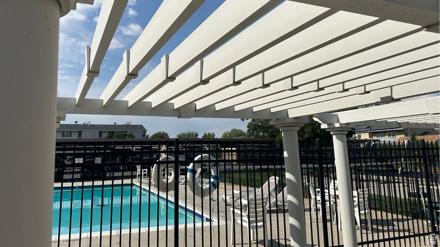 Enjoy convenient downtown and airport access with this simple secure condo! Newer flooring and appliances, smart doorlock and Nest thermostat, nestled on the mid level for optimal utility savings.    Peaceful high views of sunrise mountains to the east, yet main living area enjoys a shaded tree view.  This desireable end unit has quick access to stairs, and the added security of gated parking and common area just for residents.     Beautiful private pool and playground area plus ample on street parking.  Buyer to verify all listing info.