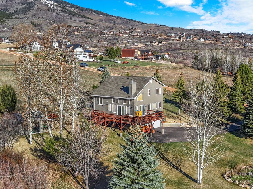 This beautiful 3-bedroom, 2-bathroom home offers 2,132 square feet of comfortable living space on 1.5 acres spread out across two lots in the desirable Bear Lake West Lakeside Estates community. Thoughtfully designed for both everyday living and relaxing getaways, the home provides an ideal balance of space, comfort, and functionality. Take in stunning, unobstructed views of Bear Lake, surrounded by wide-open spaces and the natural beauty of mature pine and aspen trees that create a peaceful, private retreat. Whether you're enjoying a quiet sunrise from the deck or unwinding in the evening, the setting is truly unforgettable. The property includes access to community amenities such as a scenic golf course, pickleball, and lake access-perfect for boating, swimming, and making the most of everything Bear Lake has to offer. Outdoor enthusiasts will appreciate being just minutes from hundreds of miles of mountain trails and the lake's sandy beaches. With plenty of room to spread out, this property is offered fully furnished, making this home move-in ready  for a full-time residence, second home, or vacation getaway in the sought-after Bear Lake Valley.