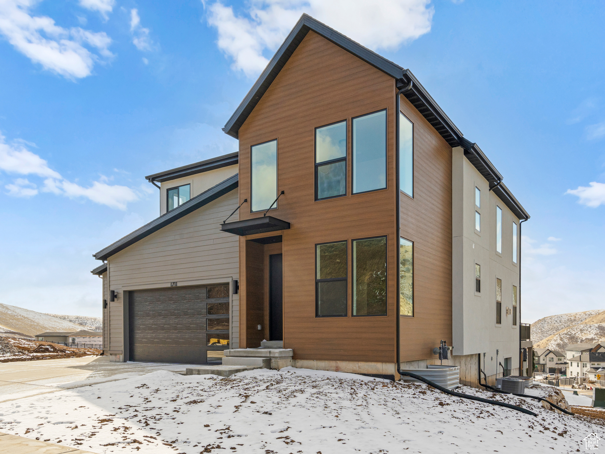 This amazing Summerwood Contemporary floor-plan in our upscale Canyon Point community on Traverse Mountain is now completed and available! This beautiful richly appointed home includes a 2-story open to below great room that floods the home with light, high end kitchen with beautiful two tone cabinets, gourmet Kitchenaid appliances including double ovens, 5 burner gas cooktop with stainless steel vented hood, 8x3' Kitchen Island, stunning tile backsplash to the ceiling, quartz counters with thick 6cm edge, 2-story fireplace, mudroom bench, stunning black open railing, black windows, huge deck with views of the valley below, 3 car garage, fully finished basement, laminates throughout the entire main level & master bedroom. The home features a walkout basement with a wonderfully functional partially fenced side and back yard and builder will finish the full front yard in the spring. The amazing community includes a huge luxury clubhouse for community events, an amazing beach entry pool with lap swimming area, tennis courts, basketball courts, multiple parks and an extensive trail system leading directly into the canyon!  Additional lender incentives available.  Contact Primary listing agent for additional information.