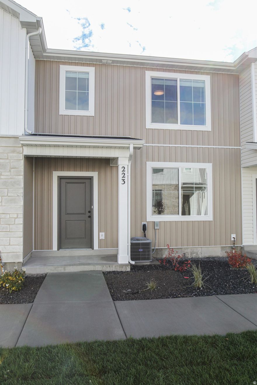 Seller offering a $10,000 incentive PLUS a fridge, washer, and dryer for a limited time! Also take advantage of the $20,000 first time home buyer grant from the state of Utah! Come check out this beautiful NEW townhome in an amazing community! This home has a 2 car garage, a large open kitchen and living space with high quality finishes including quartz countertops, LVP flooring, and stainless steel appliances. Upstairs you'll find 3 bedrooms, including a large primary suite with its own walk in closet. Pre plumbed for a water softener. Garages are fully insulated. We use blown in insulation. Premium high pylon carpet and carpet pad. Enjoy all the amazing community amenities like the premium clubhouse, pool, spa, dog park, pavilion, basketball court, pickleball court, & playground. Enjoy beautiful views from this incredible location as well. HOA covers all exterior landscaping maintenance, exterior building maintenance, snow removal on driveways, property & liability insurance coverage, trash and internet up to 1 gig of high speed fiber optic. Two year builder warranty included. Pictures are of a previously built unit. Scheduled to be move in ready in October. Square footage figures are provided as a courtesy estimate only and were obtained from sales brochure. Buyer is advised to obtain an independent measurement.