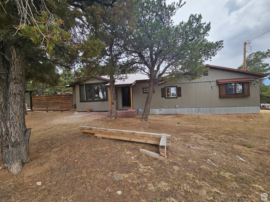 This beautiful home located close to Hwy 40 with year round access. The lot has large pinion trees with a nice yard. The home was built with love and comfort in mind. Large windows to enjoy the amazing views and wildlife.  If you are looking for a nice quiet retreat this would be perfect on a dead end road with limited traffic. The home is secluded and would be a great vacation home or investment for a rental. The cement pad is completed for a hot tub and there is a large screen outside for a projector. The proper permits were not purchased for the home and didn't undergo the inspections. Part of this home is not on a permanent foundation and on railroad ties. That is why this home will not qualify for lending and cash only. An addendum will need to be signed stating the buyer is aware of the Note of Noncompliance due to the permits and missed inspections.