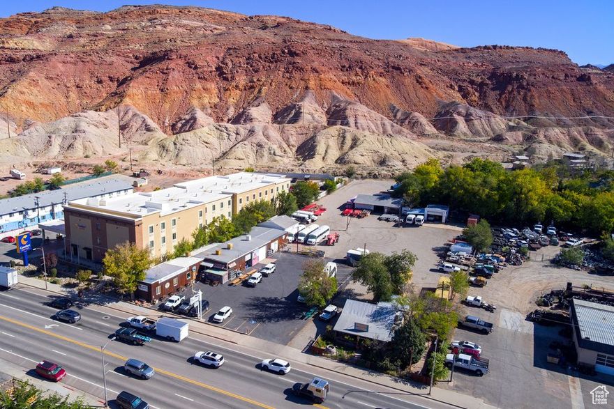 Location is excellent at 376 N. Main St. with great C-3 zoning.Business not for sale. Gteat Hwy./Main St. exposure with 197 ft.. Listing includes parcel # 01-0001-0056 (previously Eklectic Cafe). Presently houses Adrift Adventures & previous Eklectic Cafe. Retail Space, Customer counter, upstairs office, two attached overhead door garage/utility space with bathroom and cellar. Four detached shop/garage buildings. Total of 1.92 acres.  No fixtures included.  Great opportunity for rental space or beginning a new business or development. Everything which C-3 Zoning allows . See attachments. Adjacent property at Grand Tire also available and contains 1.57 acres. Great opportunity for development.