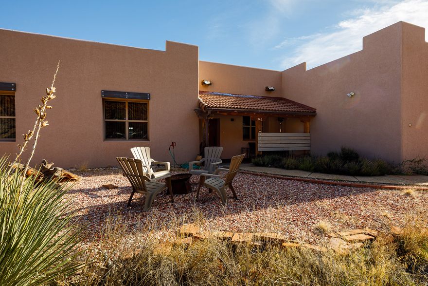 Capturing unobstructed red cliff views from both interior living spaces and outdoor retreats, this Southwest-inspired residence offers 2,197 sq ft on 1.05 acres right in Kanab. Currently operating as a successful, income-producing vacation rental with a solid three-year history, the property is offered turnkey and presents a seamless transition for continued use or a primary residence. Designed to enhance the natural landscape, the home features timeless tile flooring, vaulted ceilings, sky lights, and expansive windows showcasing the legendary Kanab backdrop. The kitchen includes bar seating and connects to a dining area with stunning views. The 3-bedroom, 2-bath floorplan is anchored by a peaceful primary suite with direct patio access and a private sauna. Outdoor living shines with covered and uncovered patio areas overlooking the sunsets, sunrises, starry skies and the Red Cliffs. The acreage accommodates horses, includes fenced pet-friendly areas, and offers a 220 sq ft storage shed. Experience the quiet, open space of desert living with close proximity to trails, recreation, and town conveniences. Buyer to verify all.