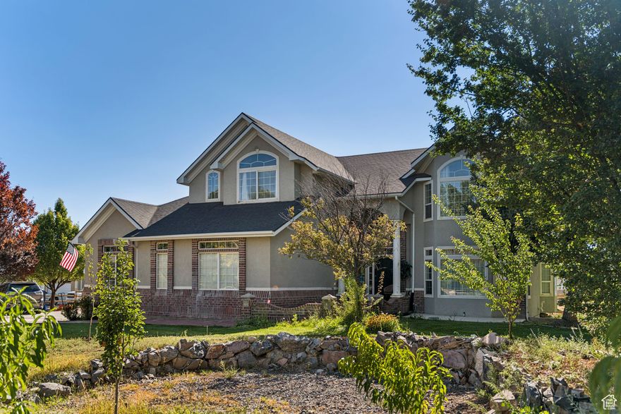 Spacious 2-story on a full acre with open great room, kitchen, dining, formal dining, and office. Upstairs features oversized bedrooms and a large primary suite with private deck, jetted tub, and shower. Finished basement offers a game/family room, 540 sq. ft. theater, kids' play area, walk-in safe with vault door, and outside entrance. Enjoy a 500+ sq. ft. patio, extra large 36'x40' powered barn/shop, corral areas for animals, and ample parking for RVs and toys. Quiet country living with room to spread out. Solar panels are included with the home and will be paid off by the seller at closing.