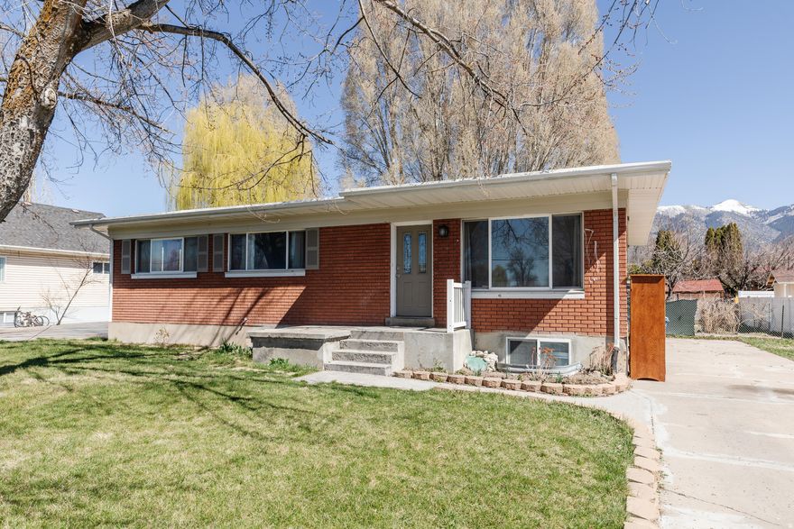 Looking for a roomy rambler in a convenient Logan location? Look no longer! This one is close to Willow Park, the fairgrounds, the river walk trail, & Shopping. It has 5 beds, 3 baths, an entry way, a bright & open kitchen with a pantry, a formal living room a cozy corner fireplace, a large family room in the fully finished basement, a good sized main-floor primary suite, & shows its character in its arched doorways & all-brick exterior. It even has a fully fenced yard! Don't wait to schedule your showing as this one is ready for a new owner to come in and put their personal touch on it. (Square footage figures are provided as a courtesy estimate only & were obtained from county records. Buyer to verify all information.)