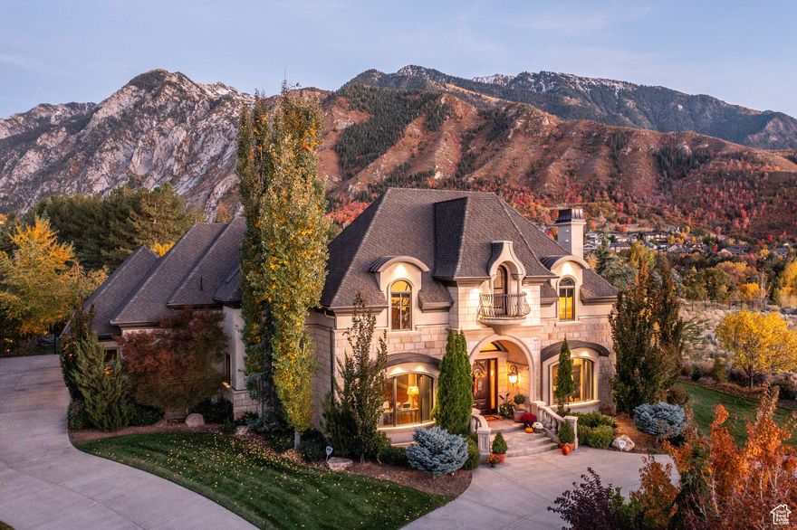 Nestled in the picturesque neighborhood of Granite Oaks and at the mouth of Little Cottonwood Canyon, this property stands as a testament to refined living. A harmonious blend of modern elegance and timeless design, this home boasts a commanding presence. The exterior, adorned with stone accents and manicured landscaping provides a desirable curb appeal. A circular driveway leads to a spacious 4 car garage, seamlessly integrating for convenience and usability. As you step inside, the interior unfolds with an open concept floor plan, limestone finishes, distressed walnut floors, custom finishes and materials throughout, and an abundance of natural light cascading through large windows, illuminating the stylish upgrades. The gourmet kitchen, adorned with granite countertops, limestone range hood, and state-of-the-art appliances, custom alder cabinetry make it a culinary haven. With multiple living spaces including a vaulted family room, main level office, workout facility, theatre room and a basement walkout allows this residence to effortlessly accommodate both intimate gatherings and grand celebrations. The primary suite is a sanctuary of tranquility, featuring a spa-like bathroom, cozy fireplace and double walk in closets. The backyard oasis, complete with a patio, lush greenery, and featuring a pool and spa that mirror the majestic mountains and provide an amazing serene retreat. Conveniently located near amenities such as top rated schools, World Class Ski Resorts including Snowbird and Alta, private and public golf facilities, hiking and biking...this location invites an active yet practical lifestyle. In every detail, this luxurious property epitomizes a home where sophistication meets comfort and also offers an unparalleled living experience in the heart of Sandy.