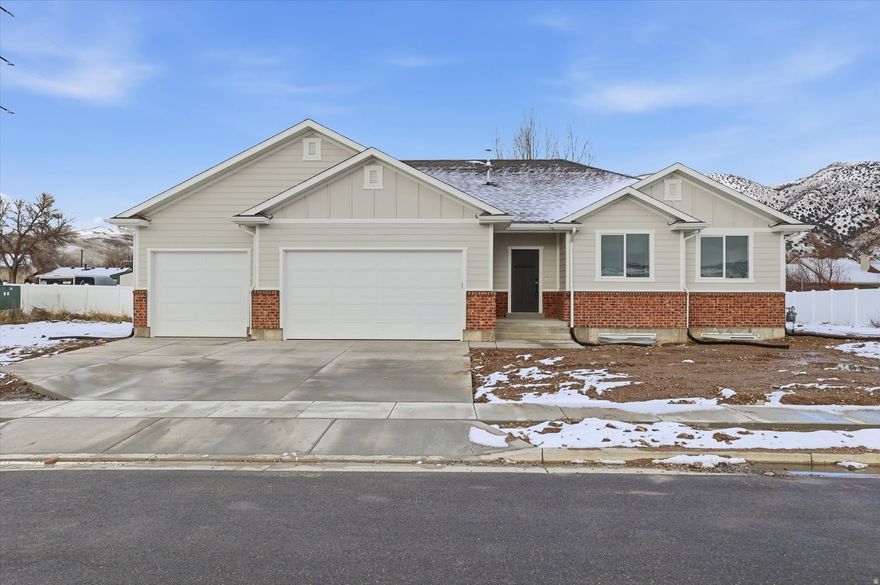 Beautiful new home located in the heart of Morgan! This thoughtfully designed property features a bright, open floor plan with vaulted ceilings and plenty of windows for natural light. The kitchen showcases quartz countertops and beautiful custom cabinetry- perfect for cooking, entertaining, and everyday living. The primary suite offers a relaxing retreat with a beautifully finished bathroom featuring a separate tub and shower, along with a walk-in closet. You'll love the oversized 3-car garage, complete with an extra-deep third bay to store toys, tools, or recreational gear. A convenient set of stairs from the basement to the garage provides excellent potential for transforming the lower level into a private mother-in-law apartment or separate living space. Enjoy the serenity of country living, stunning mountain views and easy access to outdoor recreation. This is a home you won't want to miss!