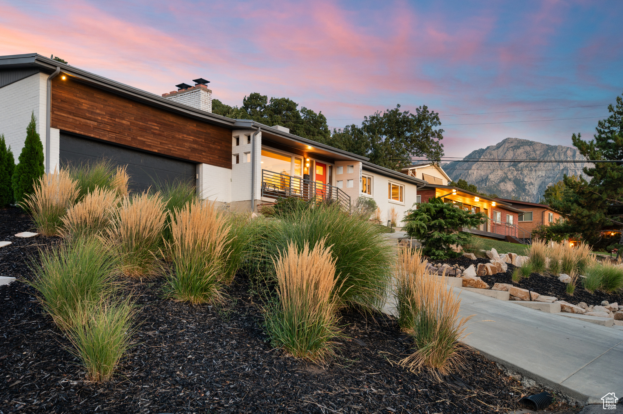 Perched high above the valley, this beautifully updated mid-century rambler offers sweeping views and modern comfort in one of Salt Lake City's most desirable neighborhoods. With 5 bedrooms, 3 baths, and 2,627 square feet, this home perfectly blends timeless design with contemporary updates. Step inside to discover an open-concept living space, highlighted by a cozy fireplace, abundant natural light, and a seamless flow into the kitchen and dining areas. The primary suite features its own private bath, creating a relaxing retreat. The kitchen boasts sleek cabinetry, stainless steel appliances, and quartz countertops, making it both stylish and functional. Enjoy outdoor living at its finest with a quiet backyard and spacious patio, ideal for entertaining, dining under the string lights, or simply taking in the surrounding mountain beauty. Additional highlights include an attached garage, thoughtful updates throughout, and a warm mid-century vibe that gives this home its unique character.